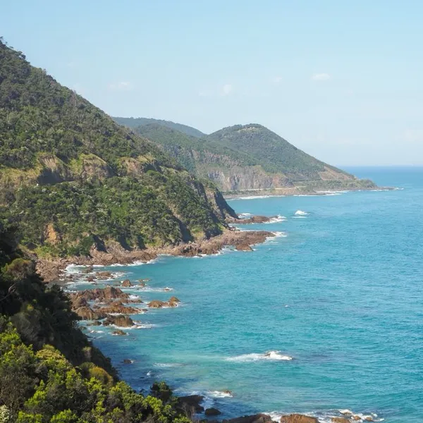 The Great Ocean Road, with the ocean on the left and a cliff on the right.
