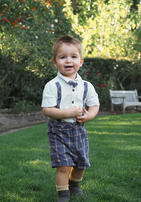 A boy smiling, standing and having fun